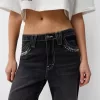 Vaqueros anchos estilo años 90 con tachuelas